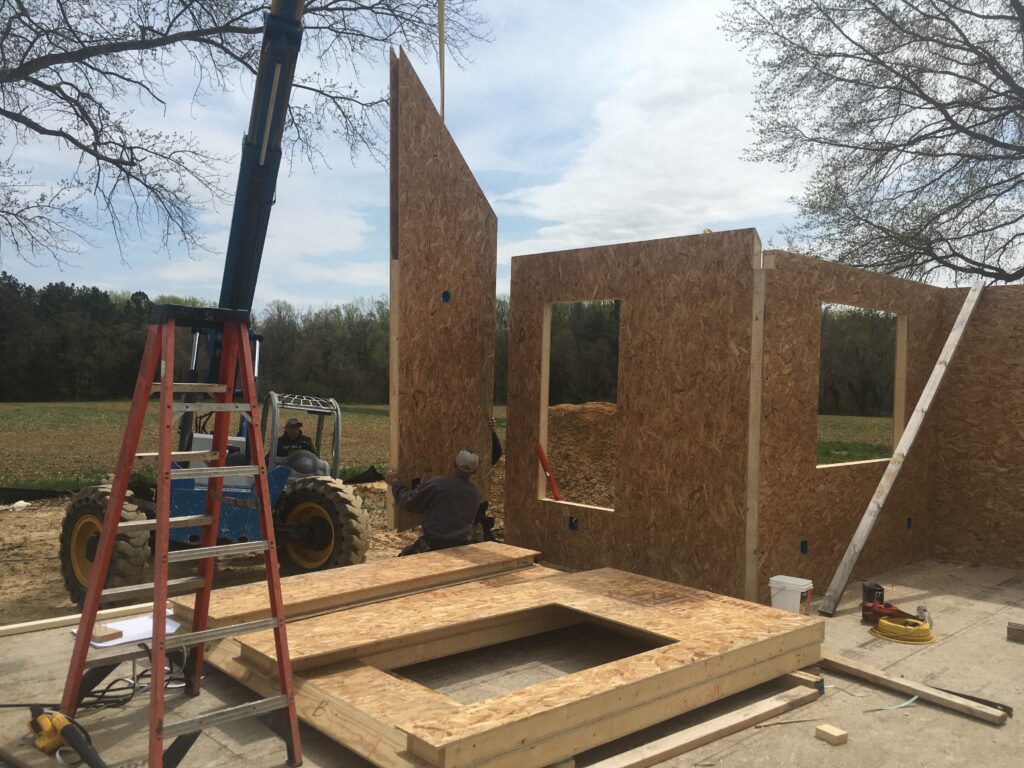 Sustainable construction - SIP walls stacked and being erected